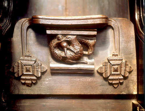 Misericord of beast and child, Great Malvern Priory, Worcestershire