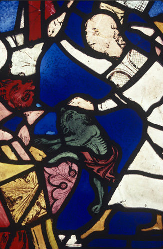 Chasing away a group of devils, detail of a panel in the east window of the north choir aisle in Lincoln Cathedral, England 13th century