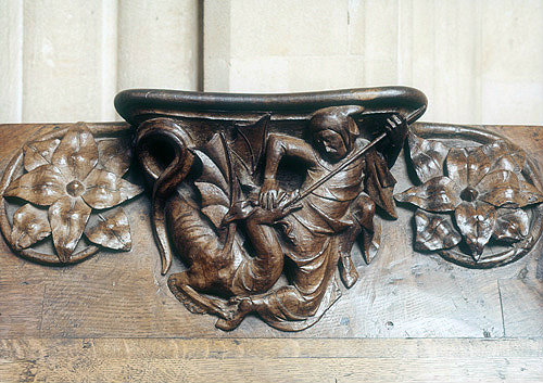 Misericord in Wells Cathedral, Somerset, man spearing a dragon (possibly St George),  circa 1330-40 AD