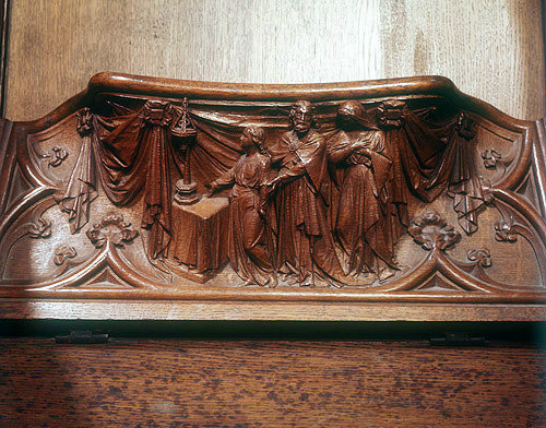 Misericord in Gloucester Cathedral, Gloucestershire, presentation of a youth in the temple, either Christ or Samuel