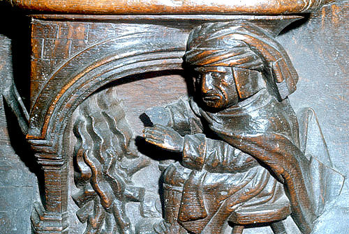 Misericord of Labour of the month, January, man warming himself by the fire, fifteenth century, St Mary