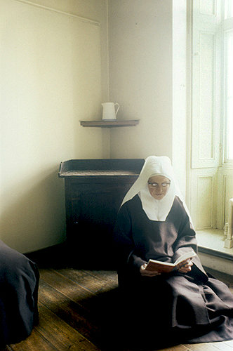 Sister reading in cell, Thicket Priory, Thorganby, North Yorkshire, England