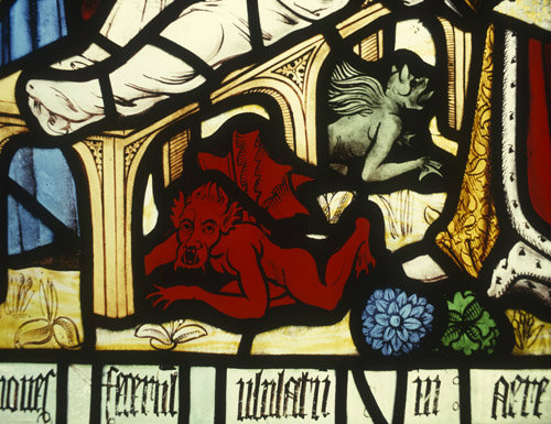 Devils cast out, detail from a window in St Matthews Church at Morley, Derbyshire, England