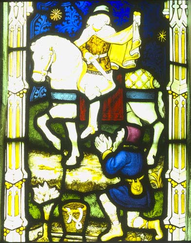 St Martin cutting cloak for a beggar, stained glass window 1918 by H Bryans, designed by Ernest Heaseman, Church of St Mary, Newton Valence, Hampshire, England, Great Britain