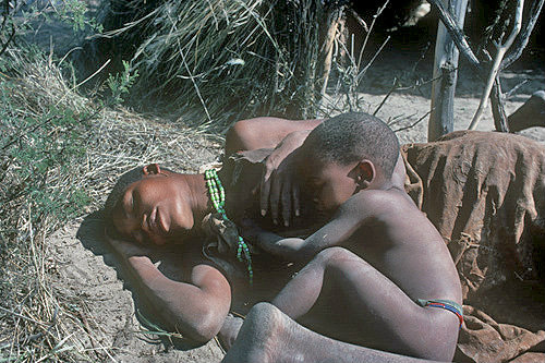 Kua Bushman woman Malepae resting with her son, Kalahari, Southern Africa