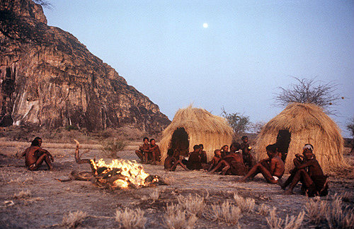 Bushman group sitting around a camp fire, Kalahari, Southern Africa