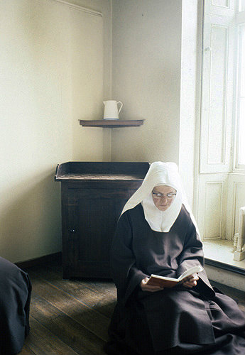 Sister Elizabeth Carmel reading in her cell, Thicket Priory, Thorganby, North Yorkshire, England