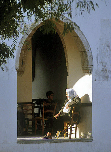 Bellapais, local woman sitting outside café, Northern Cyprus