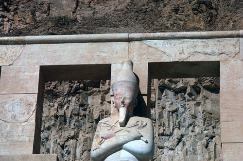 Egypt, Thebes, facade of mortuary temple of Queen Hatshepsut, one of a line of Osiride statues of Hatshepsut, characteristically represented as a male king with a beard, crook and flail