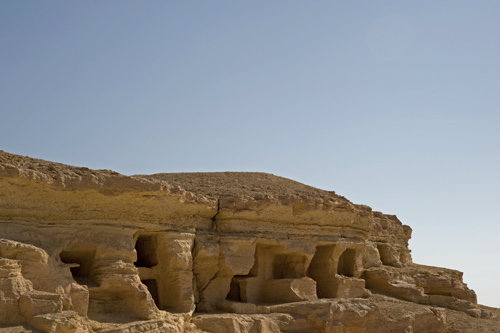 Egypt, Siwa, Hill of the Dead, (Jabal al-Mawta), tombs and loculi from XXVI Dynasty, Ptolemaic and Roman periods, view South with Jabal Dakhrour in background