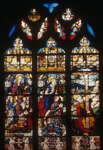 Crucifixion with donor Guy de Laval kneeling in centre light, 16th century stained glass, Church of St Martin, Montmorency, France