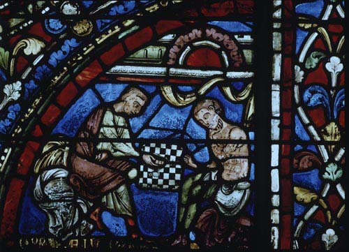 Prodigal son playing dice, 13th century stained glass, north transept, Chartres Cathedral, France