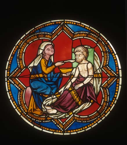 Feeding the Hungry, 13th century stained glass roundel, Acts of Mercy window, rose in north transept, restored 1931 by Fritz Geiges, Freiburg Munster, Germany