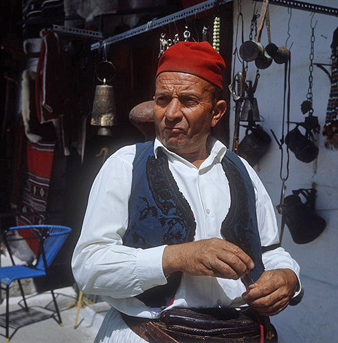 Shopkeeper in traditional costume, Langadia, Greece
