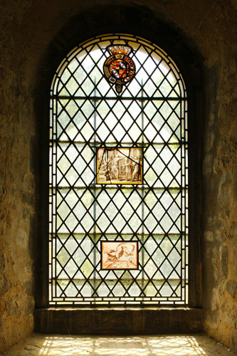 Stained glass panels in window in the Chapel of St John the Evangelist, White Tower, Tower of London, photo Historic Royal Palaces