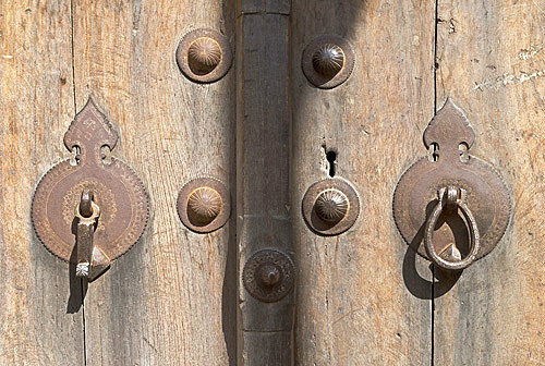 Wooden door with male and female knockers, Yazd, Iran