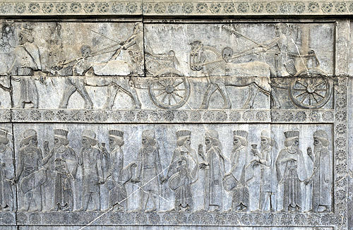 Relief of Persian and Mede dignitaries in procession below royal chariots and horses, east staircase of Apadana palace (audience palace), Persepolis, Iran