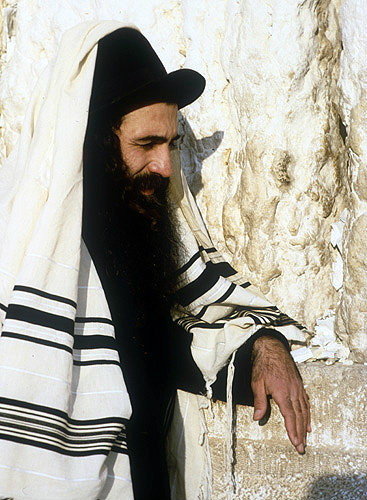 Israel, Jerusalem, an Ashkenazi Jew at the Western Wall where written prayers are placed in the wall by devout Jews