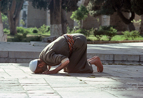 Israel, Jerusalem, Muslim man praying near the Dome of the Rock