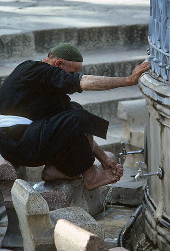 Israel, Jerusalem,  Dome of the Rock, Arab at Ablutions Fountain before praying