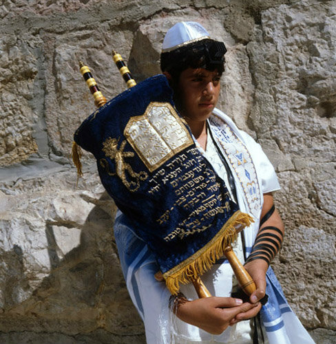 Israel Jerusalem Sephardic Jewish boy holding the Torah at his Bar Mitzvah at the Western Wall
