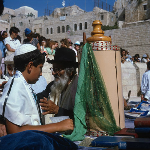 Israel Jerusalem Sephardic Jewish boy at his Bar Mitzvah ceremony with the Torah and Rabbi at the Western Wall