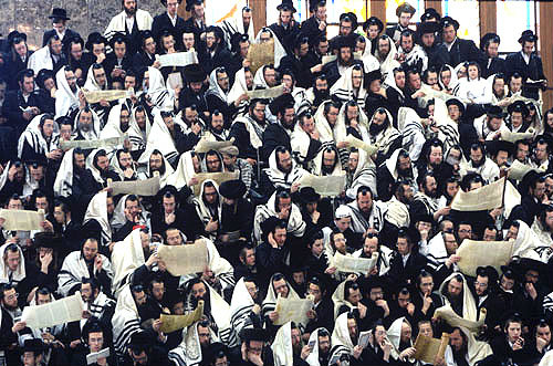 Ultra-Orthodox Jewish men and their sons follow the reading of the Megilat Esther during the festival of Purim, Vizhnitz Yeshivas Synagogue, Bnei Brak, Israel