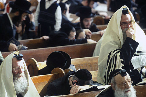 Ultra-Orthodox Jewish men and their sons follow the reading of the Megilat Esther during the festival of Purim, Vizhnitz Yeshivas Synagogue, Bnei Brak, Israel