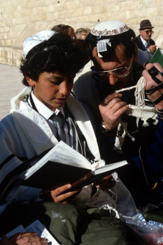 Israel Jerusalem boy reading prayers with his father during his Bar mitzvah ceremony at the Western Wall