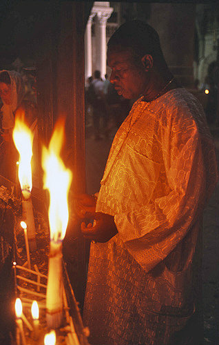 Israel, Jerusalem, a pilgrim prays at the fourteenth Station of the Cross, the Tomb of Jesus