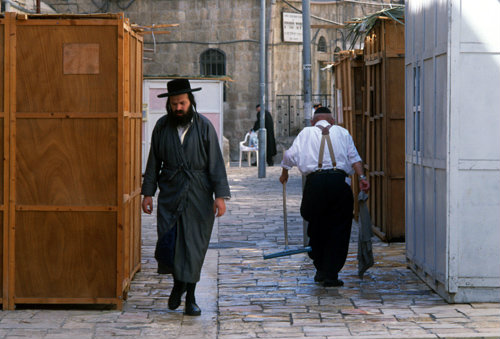 Israel Jerusalem religious Jews pass between Sukkahs in the Ultra-Orthodox neighbourhood of Mea Shearim