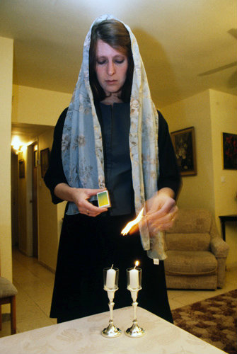 Israel Jerusalem a Jewish woman lighting Sabbath candles at home