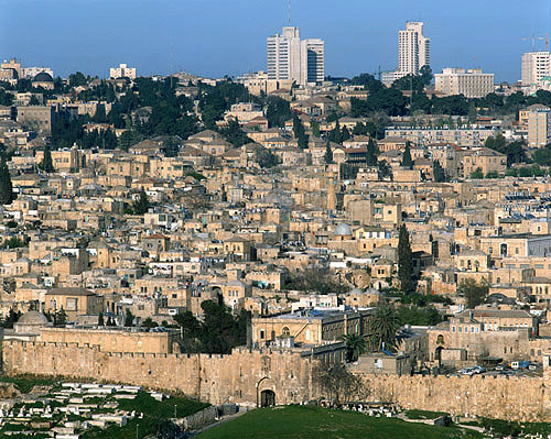 Israel, Jerusalem St Stephens Gate and the City Wall, high rise buildings beyond the old city