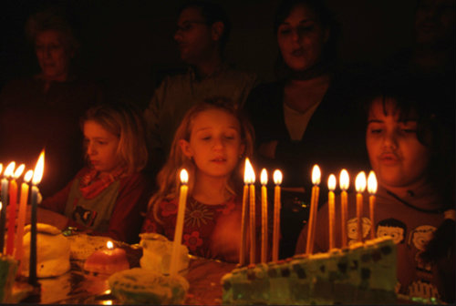 Israel modern Jewish families light Hanukkah candles together