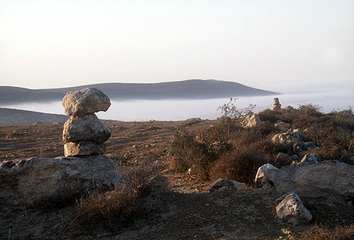 Israel, boundary marker stones north of Beersheva, mist in the valley beyond