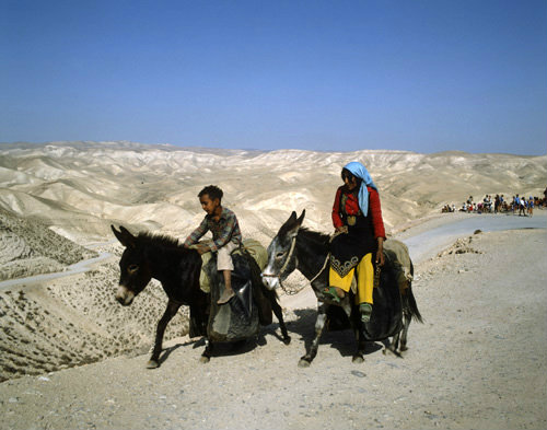Israel, Judean Hills, girl and boy returning with water from a spring in Wadi el Qilt