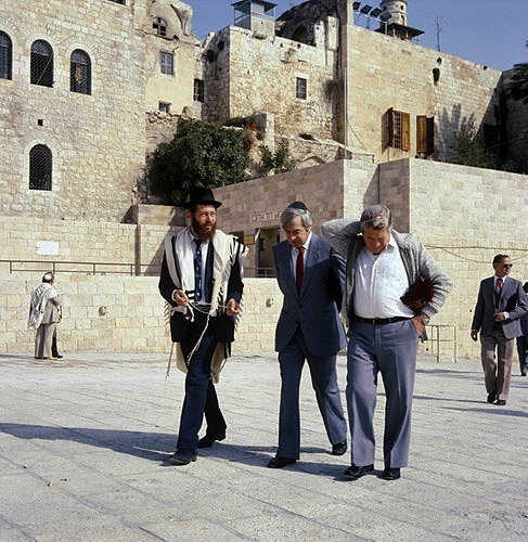 Israel, Jerusalem, three Jews walking away from the Western Wall deep in conversation