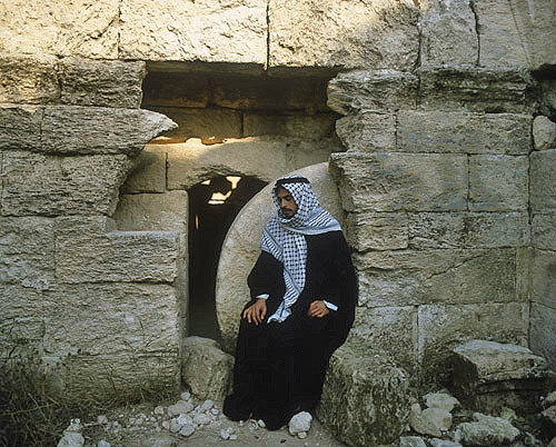 Arab outside rolling stone tomb, similar to that of Christ, south west of Hebron, Israel