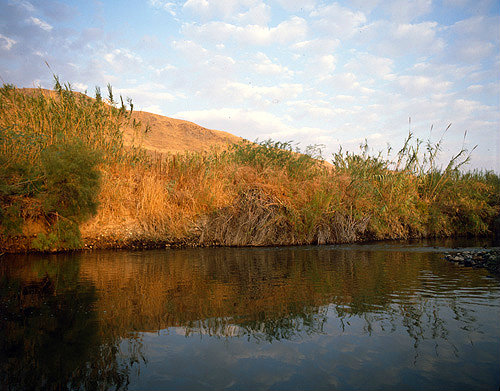 Israel the Jordan River south of Galilee in the early morning sunlight