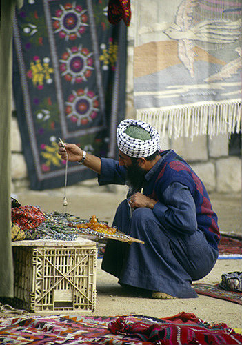 Bedouin trader checking his wares, Bedouin market, Beersheva, Israel