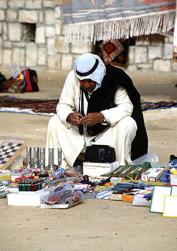 Israel, Beersheva, Bedouin market, Bedouin man checking his wares
