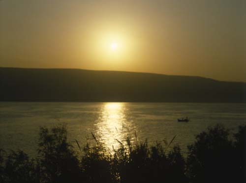 Sea of Galilee, just after sunrise, with  fishing boat, Israel