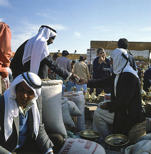Israel, Beersheva, market, Arabs bargaining  over a sack of almonds