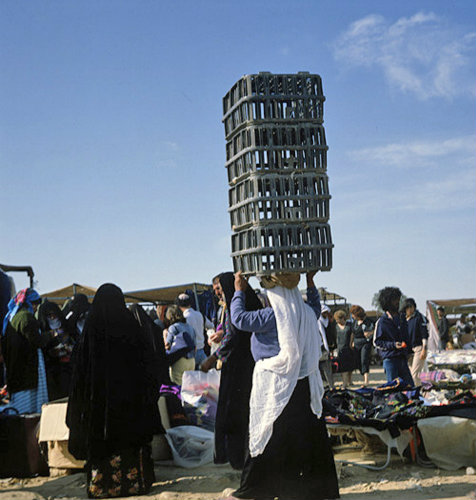 Israel, Beersheva, market, Bedouin woman carrying four crates on her head