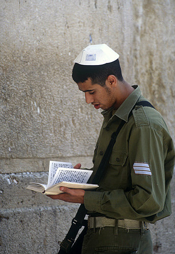 Israel,  Jerusalem,  a Jewish soldier reading from the Jewish Bible at the Western Wall