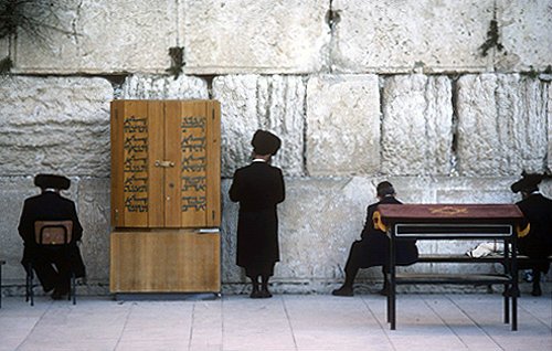 Israel, Jerusalem, Orthodox Jews praying at the Western Wall by the Torah cabinet