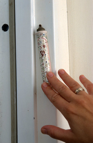 Israel Hod Hasharon a Jewish woman touches a Mezuzah on her doorpost on her arrival or on her departure