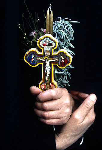 Israel, Jerusalem, Good Friday on the Via Dolorosa hands holding a crucifix and candle
