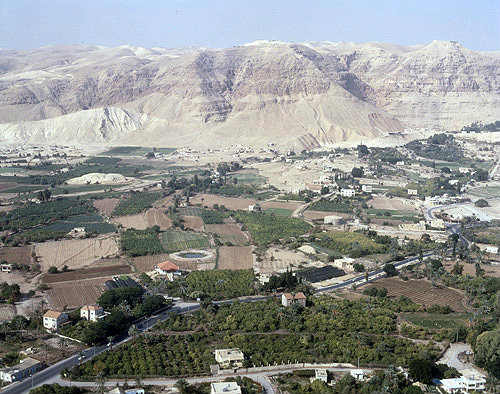 Citrus grove round resevoir, Monastery of Temptation in background, aerial photograph, Jericho, Israel