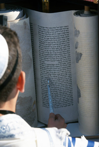 Israel Jerusalem a Bar mitzvah, boy holding a Yad whilst reading from the Torah